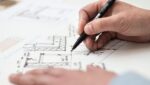 renovation planning concept man drafting building plans