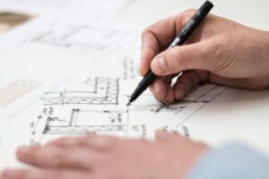 renovation planning concept man drafting building plans